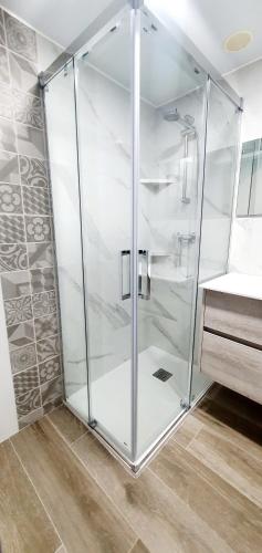 a glass shower in a bathroom with a sink at La Pedrera Font Nova in Peniscola
