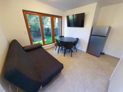 a living room with a table and a refrigerator at Tisa Homes in Savudrija