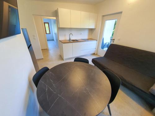 a kitchen and a table in a room at Tisa Homes in Savudrija