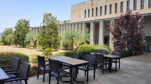 a group of tables and chairs in front of a building at Hostatgeria de Poblet in Poblet