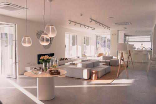 a living room with a couch and a table at Radisson Resort Plaza Skiathos in Kanapitsa