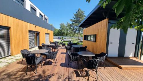 a deck with tables and chairs on a building at Hotel CityMap Maribor in Maribor