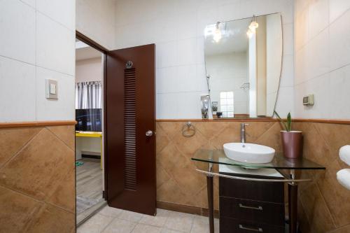 a bathroom with a sink and a mirror at Casa Heradurra Uno/Dos in Manila