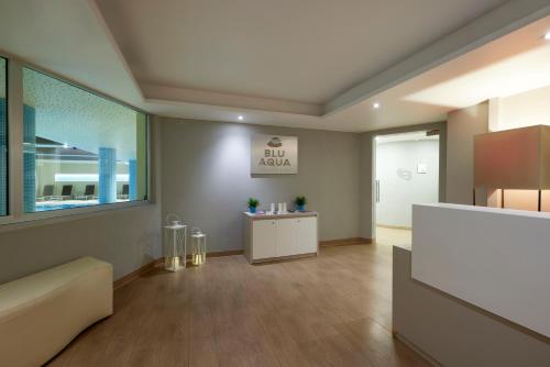 an office with a waiting area with a large window at Grand Hotel Misurina in Misurina