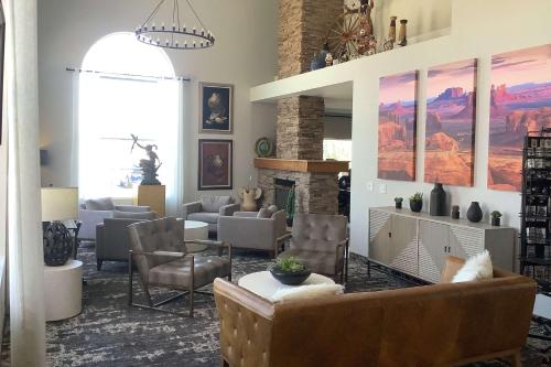 a living room with couches chairs and a fireplace at Baymont Inn & Suites by Wyndham Holbrook in Holbrook