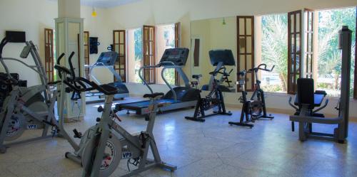 a gym with a bunch of exercise bikes and treadms at Palais Du Desert Hotel & Spa in Erfoud