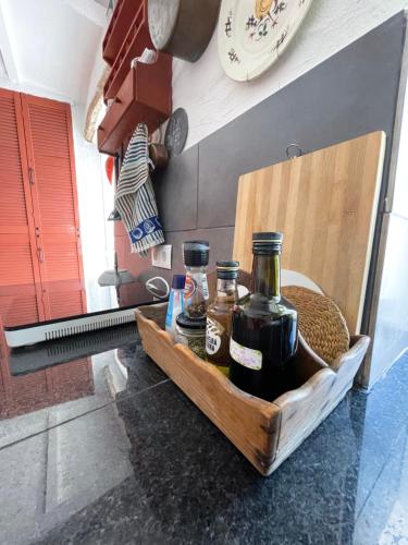 a wooden tray with two bottles of wine on a counter at Monte Carrascal Guesthouse in Salir