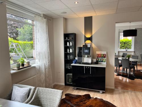 a living room with a table with a coffee maker at Hotel Garni am Obsthof GbR in Stade