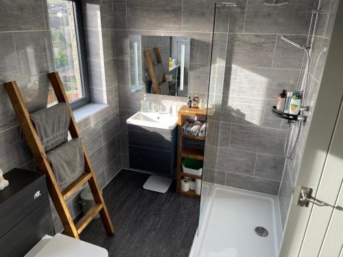 a small bathroom with a shower and a sink at Renovated apartment, Galashiels A7 in Galashiels