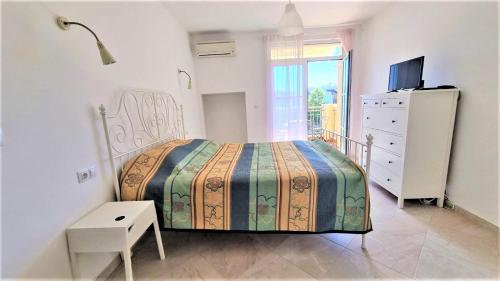 a bedroom with a bed and a dresser and a window at Beautiful Cozy Studio in a Luxury Complex in Chernomorets in Chernomorets