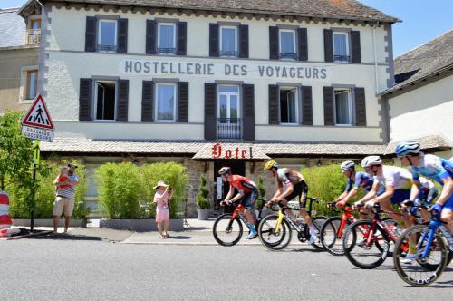 a group of people riding bikes down a street at Hostellerie des voyageurs in Cassagnes-Bégonhès