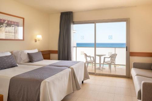 a hotel room with two beds and a view of the ocean at htop Pineda Palace 4Sup - Adults Recommended #htopBliss in Pineda de Mar