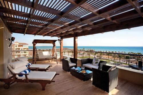 a patio with a view of the beach at Amwaj Beach Club Abu Soma in Hurghada