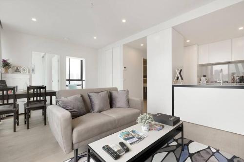 - un salon avec un canapé et une table dans l'établissement Modern 2 Beds Apartment with Amazing City View, à Melbourne