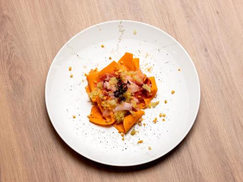a white plate with a piece of food on a table at b'mine Hotel Frankfurt Airport in Frankfurt/Main
