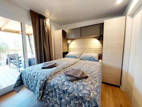 a bedroom with a bed with a tray on it at Mobile Home Mar Vista Selce in Selce
