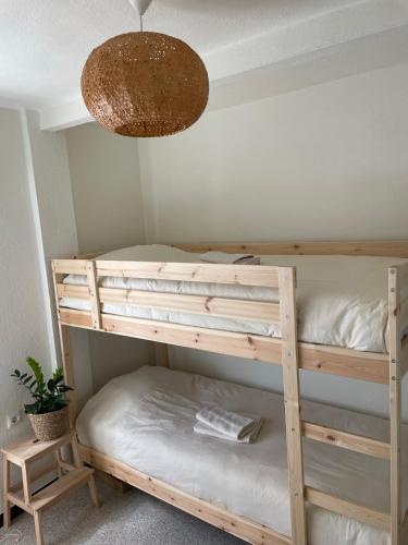 a bedroom with two bunk beds and a lamp at Casa Tajo in Tarifa