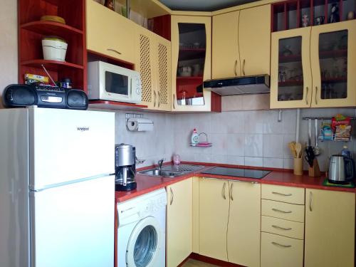 a kitchen with a white refrigerator and a washer at Brīvdienu dzīvoklis in Madona