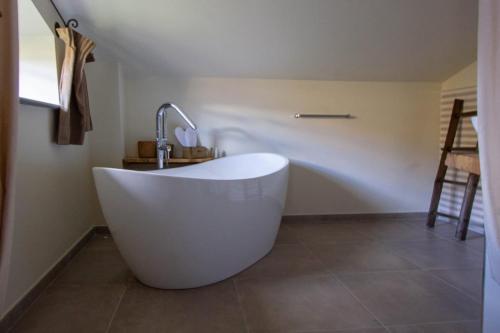 a white bath tub in a bathroom with a sink at Agriturismo I Giunchi in Mochignano