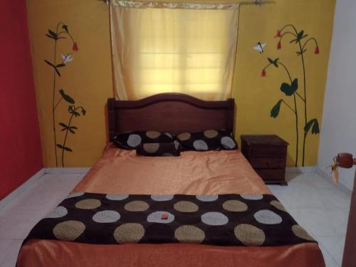 a bedroom with a bed with polka dots on it at hostal Sueño Paraiso- Observatorio astronómico in Popayan