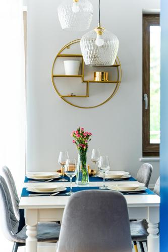 a dining room with a blue table and a gold mirror at Stone Hill Apartament Sunrise in Szklarska Poręba