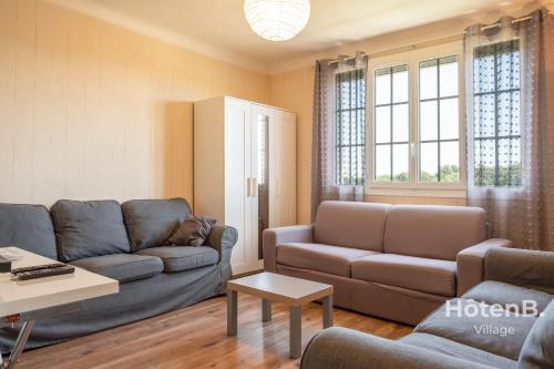 a living room with a couch and a table at Large house close to city center Limoges in Limoges