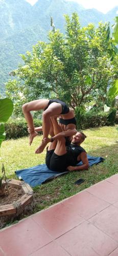 two people sitting on the ground doing a yoga pose at My's Homestay sapa in Sa Pa