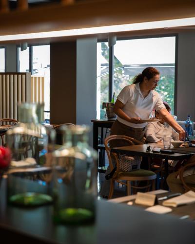 a man standing at a table in a restaurant at Nuria in Tarragona