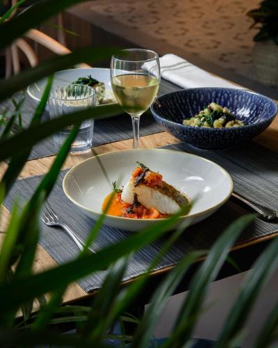 a table with a plate of food and a glass of wine at Nuria in Tarragona