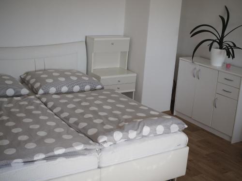 a bedroom with a bed and a dresser and a plant at Ubytování u Josefa in Vodňany