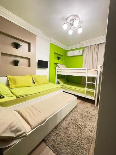 a bedroom with two beds and a bunk bed at Luxury Mamoura Alexandria Apartment شقة فاخرة بجنينة خاصة بالمعمورة الشاطئ بالإسكندرية in Alexandria