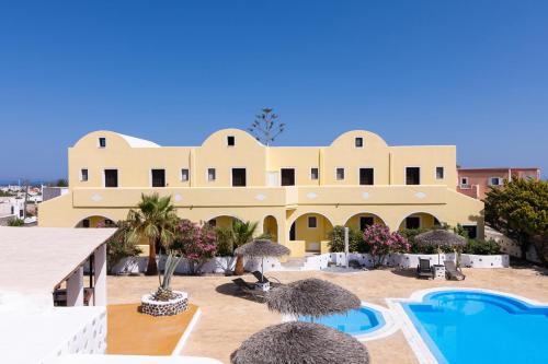 a large building with a swimming pool and a resort at Mandilaria Studios in Perivolos