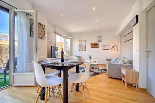 une salle à manger et un salon avec une table et des chaises dans l'établissement Le Max et Leo - 600m plage - Verrière côte d'Azur, à Cannes