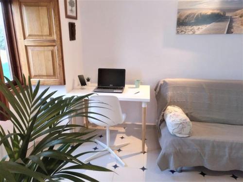 a living room with a desk with a laptop on it at Casa Nogal in La Matanza de Acentejo