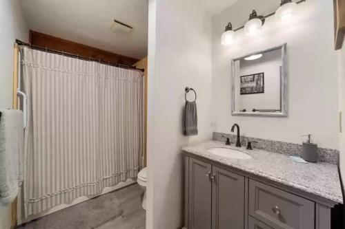 a bathroom with a sink and a shower at Buckner’s Getaway! Close to town, lake and river! in Bryson City