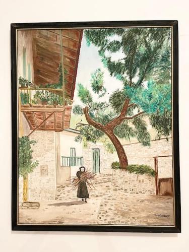 a painting of a woman standing next to a tree at The Mountain House in Ktima