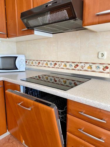 a kitchen with a stove and a microwave at Villa Adria in Vodice