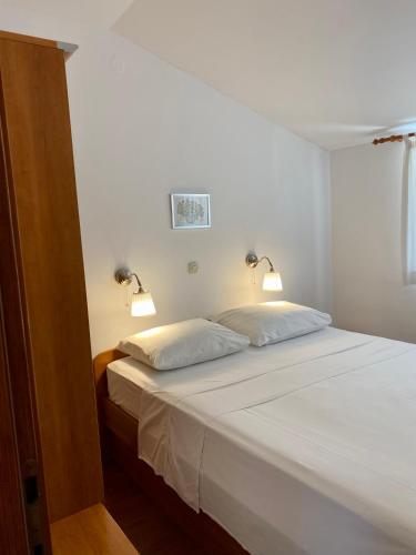 a bedroom with two beds with lights on them at Villa Adria in Vodice