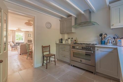 a kitchen with a stove top oven in a room at The Cottage in the Clouds in Marlborough