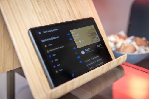 a tablet sitting on top of a wooden table at Szent Imre Apartman in Veszprém