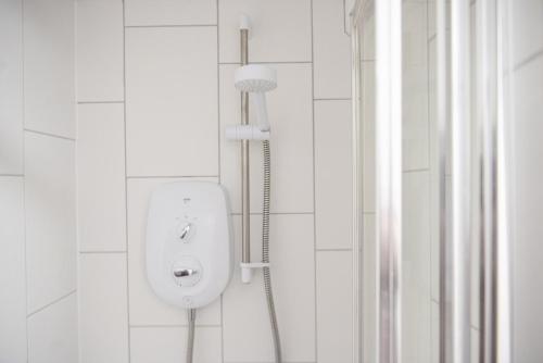 a bathroom with a shower with a urinal on the wall at Kerensa in Portreath
