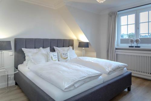 Кровать или кровати в номере Ferienhaus Sylter Sehnsucht