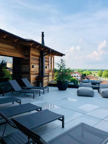 a patio with chairs and tables and a building at Ortner's Resort in Bad Füssing