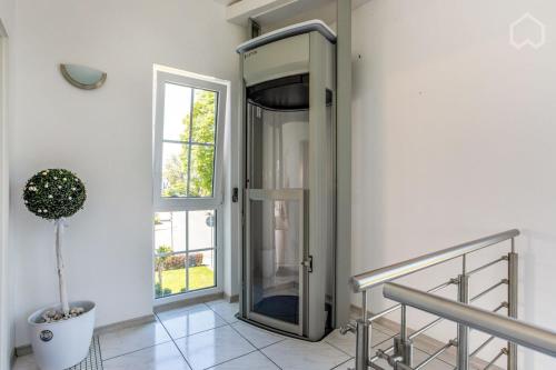 a glass elevator in a hallway with a window at Charmantes Loft Appartement in Haan
