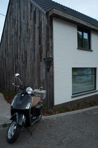 a motor scooter parked in front of a building at Boekelbaan 161 in Zwalm