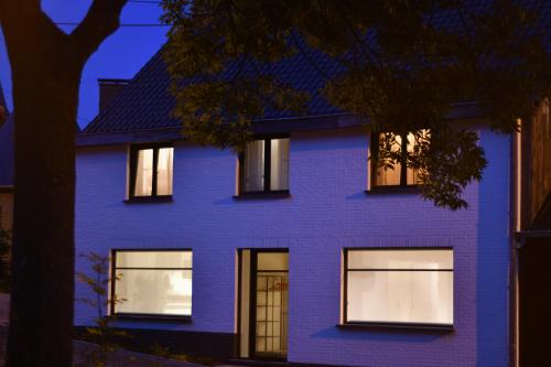 a purple house with windows at night at Boekelbaan 161 in Zwalm