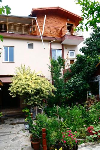a house with a lot of plants in front of it at Rosemary Pansiyon in Cıralı