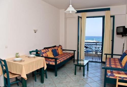a living room with a table and a couch at Marelina Villas in Panormos Rethymno
