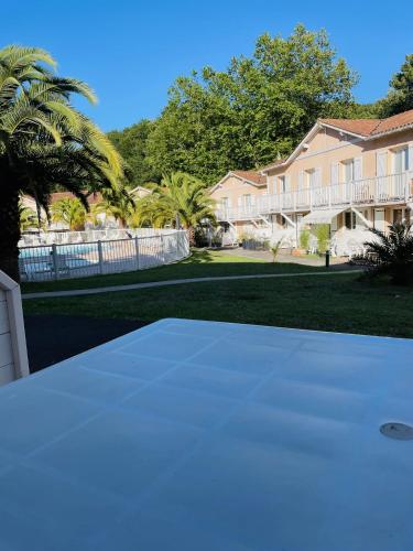 a tennis court in front of a house at Résidence LA CROISIERE in Anglet