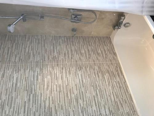 a bathroom with a rug on the floor of a room at Golden Lion Hotel in Stirling